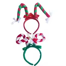 Close-up of festive Christmas headbands with striped candy cane antlers and bows