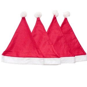 Set of four classic red Christmas hats with white plush trim for holiday parties