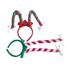Detail view of red and green striped Christmas headbands with festive bows on white background