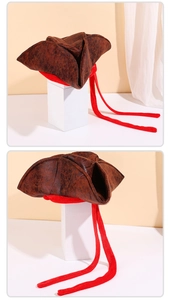 Close-up of brown pirate tricorn hat with vintage leather texture and red plush trim