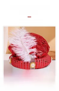Detail of red sequined Arabian hat with a large white feather and pearl embellishments