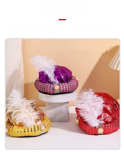 Close-up of Sultan party hats featuring sequins, white feathers, and pearls in three colors
