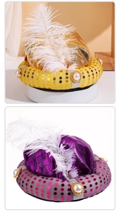 Detail of Aladdin hat with shiny metallic fabric, sequins, pearls and white feathers