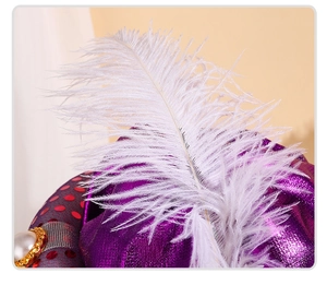 Macro detail of white ostrich feather with decorative pearl and golden lace trim
