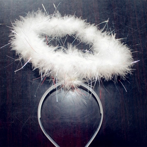 Close-up of white angel halo headband with soft feathers and silver tinsel details