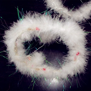 Close-up of white feather angel halo headband with colorful laser tinsel and internal LED lights