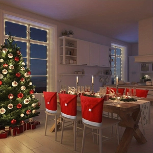 Cozy dining room scene with red Santa hat chair covers and decorated Christmas tree