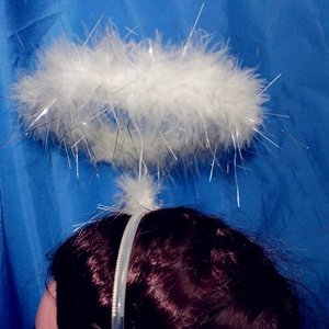 Detail of white feather angel halo headband with silver tinsel for party cosplay costume