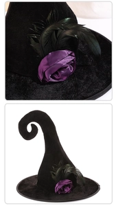 Detail view of black velvet witch hat featuring purple satin rose and feather trim
