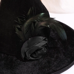 Gothic black velvet witch hat with handcrafted rose and dark green feathers for Halloween