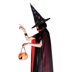 Detail view of black pointed wizard hat with star patterns and a classic pumpkin candy bucket