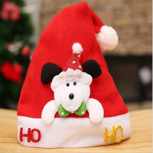 Detail of red plush Christmas hat featuring a 3D plush bear and gold HO glitter letters