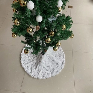 Close-up of white plush Christmas tree skirt featuring shiny silver sequin snowflakes