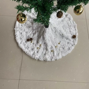 Detail of white faux fur Christmas tree skirt featuring silver sequin snowflake embroidery