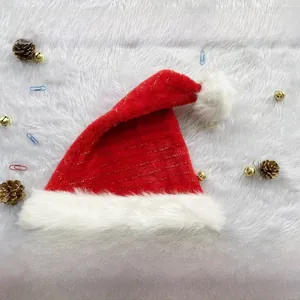 Close-up of red Christmas hat with gold wire stitching and white plush pompom and brim