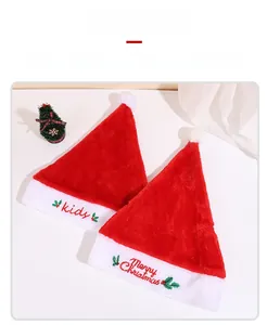 Detailed view of red velvet Christmas hats with white fur and embroidered festive lettering