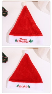 Detailed view of plush red Christmas hats with Merry Christmas and kids embroidery