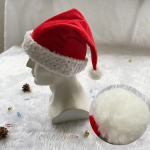 Detailed close-up showing soft white plush pompom and sequined trim on a red Santa hat