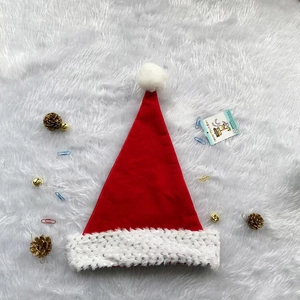 Classic red Christmas hat with sequins and white faux fur trim on a festive background