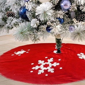 Red Christmas tree skirt with white snowflake patterns and festive holiday decorations