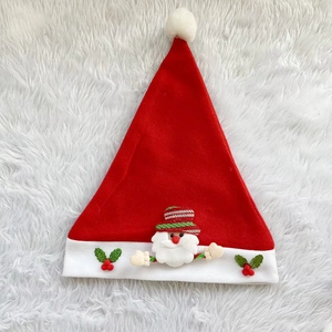 Detail view of Santa hat with 3D plush character, holly leaves and fuzzy ball