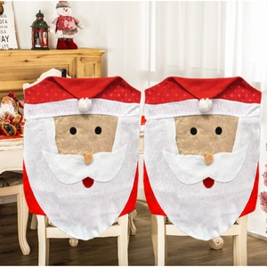 Pair of festive red Santa Claus chair covers for Christmas dining room decoration