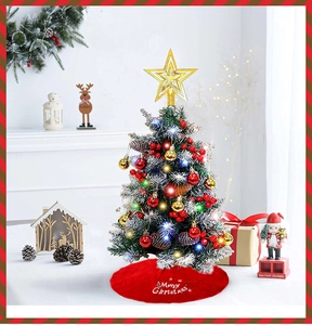 Mini tabletop Christmas tree with snowy branches, LED lights and red plush tree skirt