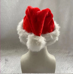 Detail of plush red and white Christmas hat featuring a soft faux fur trim and fluffy pompom
