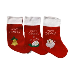 Set of three red velvet Christmas stockings with embroidered Santa and Snowman patterns