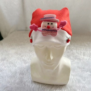 Detail of red Christmas hat with a 3D plush snowman character and soft white pom-poms