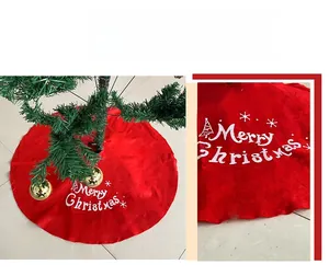 Detailed close-up of red velvet Christmas tree skirt with Merry Christmas prints