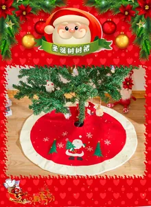 Close-up of premium red Christmas tree skirt with Santa Claus embroidery and soft plush border