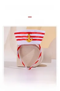 Detail of nautical headband featuring fine textured cloth and golden anchor ornament