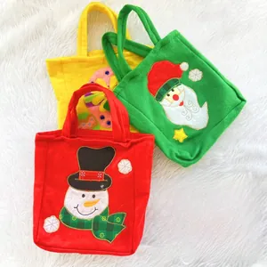 Detailed view of Christmas felt gift bags featuring Santa, snowman, and gingerbread man