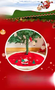 Detail of red Christmas tree skirt featuring Santa Claus embroidery and white trim