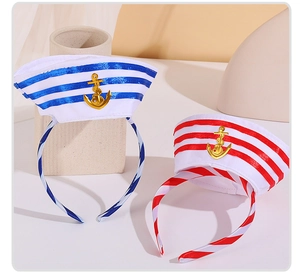 Close-up of navy blue and red striped headbands featuring golden anchor metallic ornaments