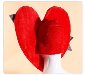 Detail of red plush heart headwear with grey wing decorations for holiday costumes