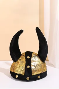 Close-up of golden Viking horn hat featuring black horns and metallic rivet details