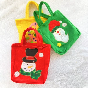 Three colorful Christmas felt gift bags featuring snowman and Santa Claus embroidery