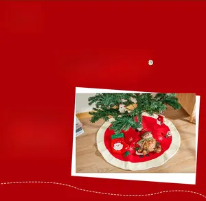 Detail of red Christmas tree skirt with premium snowman embroidery and white ruffle edges