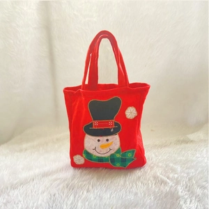 Red felt Christmas gift bag featuring a snowman design on white faux fur background