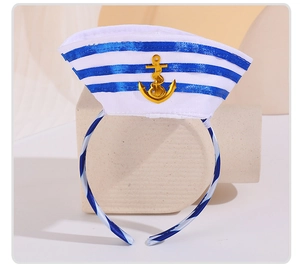 Detailed view of nautical sailor hat headband with blue stripes and gold anchor emblem