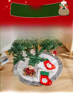 Detail of white plush Christmas tree skirt with embroidered Santa and matching socks