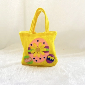 Festive yellow felt Christmas and holiday gift bag with colorful Easter egg decorations