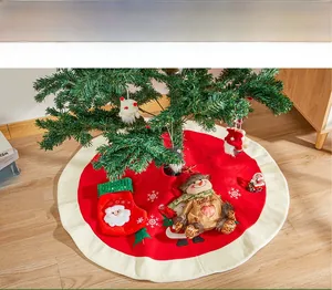 Detail of red Christmas tree skirt with plush snowman decor and white snowflake patterns