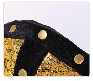 Macro detail of festive hat with gold cracked texture and brass rivets on black trim