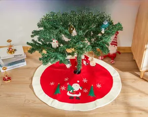 Detailed embroidery of Santa Claus and snowflakes on red Christmas tree skirt with plush trim