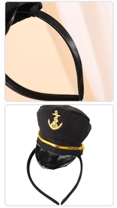 Detail of nautical captain hat headband with golden anchor emblem and braided trim decorations