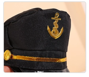 Detail of captain hat for pets featuring golden anchor emblem and braided strap