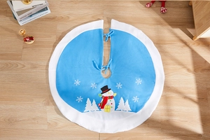 Close-up of sky blue Christmas tree skirt with snowman embroidery and white snowflakes